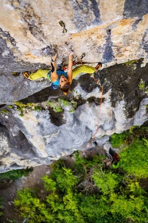 Famale rock climber climbs on rock.の写真素材