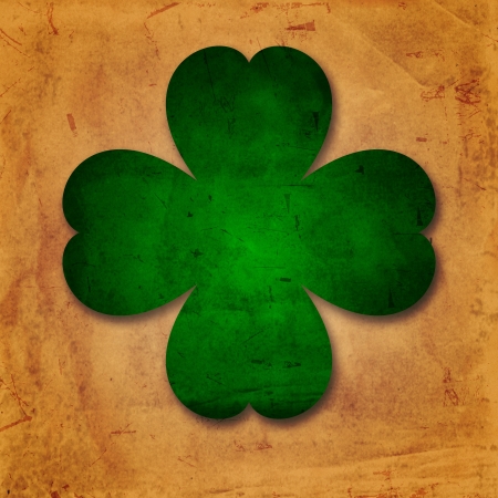 shamrocks - vintage beige background with green four-leaved flower over old paperの写真素材