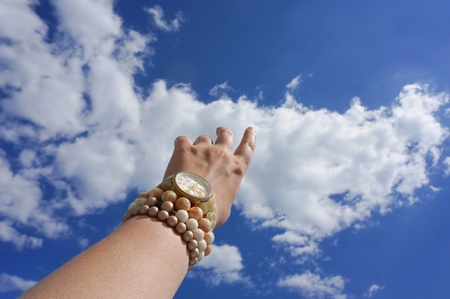 Hand trying to touch the blue skyの写真素材