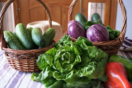 Green vegetables from market in wicker basketの写真素材