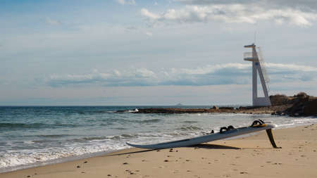 Surfing board laying on the beach ready