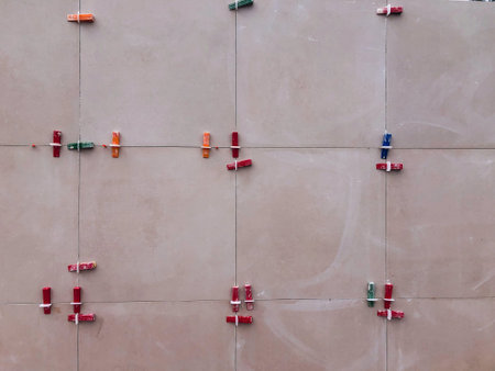 Red dirty tile clips used in making wall. High quality photo