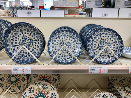 Alicante, Spain - December, 2022: Blue rustic pattern ceramic plates on shelves in Auchan...
