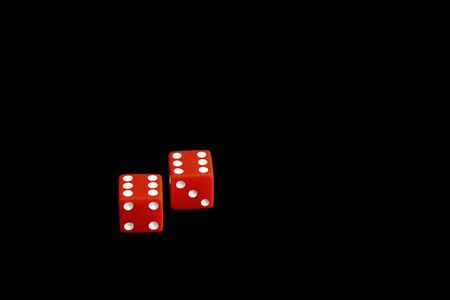 red game dice isolated on black background, casino, copy spaceの写真素材