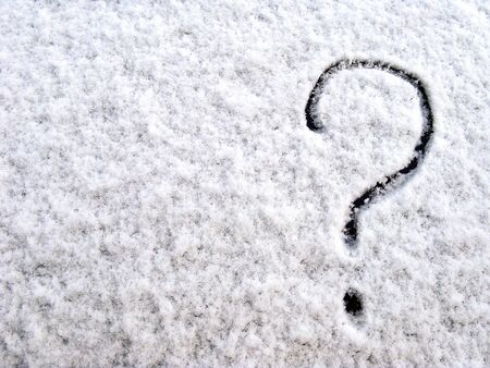 Question mark on the first fluffy snow. Early winter.  Close-up. Selective focus. Copy space.の写真素材
