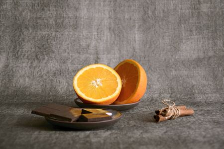 Dark chocolate, sliced orange and cinnamon sticks, close up, selective focus, copy spaceの写真素材