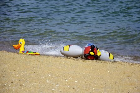 Children's inflatable toys for teaching children to swim. Bright and colorful swimming equipment on...