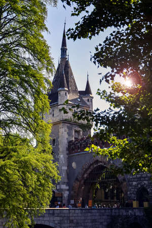 Budapest, Hungary - may, 2019: Entrance to the old castle. Tourists visit a historical place. Ancient stone tower and arched gate. Selective focus. Copy space.のeditorial素材