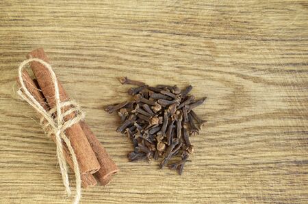 Close-up of Christmas spices. Cinnamon sticks tied with twine on old wood background. Top view. Copy space.の写真素材