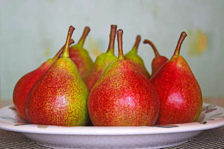 Fresh pears on ceramic plate on kitchen table. Organic ripe pear. Concept of natural healthy food....