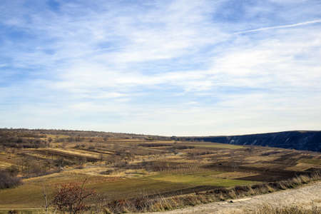 Autumn rural landscape. Harvested and plowed fields against blue sky with clouds. Selective focus....