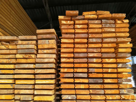 Lumber in large warehouse. Wooden boards in the stack. Edged board. Storage. Close-up. Selective...