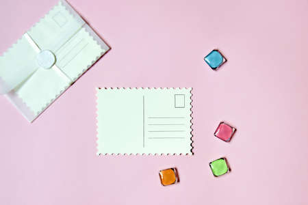 Blank vintage postcard on pink background, empty post cards, postcrossing, mockup. Top view. Selective focus. Copy space.の写真素材