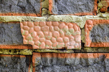 Destroyed bricks in old brickwork. Old dilapidated brick wall, natural texture, uneven surface....