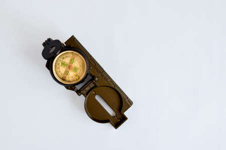 Folding military compass on blue background. Close-up. Copy space. Selective focus.の写真素材