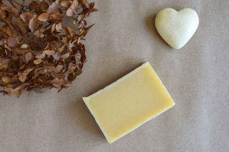 One piece of natural handmade soap, dry Hydrangea Flower and souvenir heart on craft paper....
