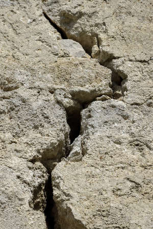 Big winding crack in wild stone masonry. Consequences of earthquake. Copy space. Shot at angle. Close-up. Selective focus.の写真素材