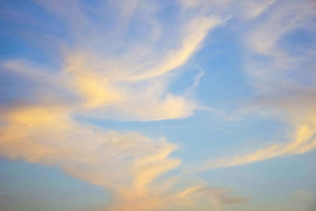 Unusual abstract pattern of cirrus clouds in sunset sky. Atmospheric phenomenon. Natural background....