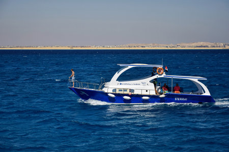 Hurghada, Egypt - October 2021: People relax on yacht sea on sunny day. Coast is visible in distance. Vacation on Red Sea, resort, holidays, leisure, travel.のeditorial素材