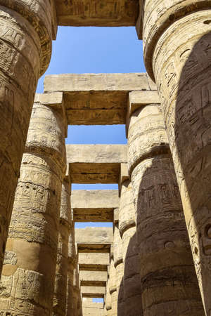 Ancient Egyptian hieroglyphs and symbols carved on columns of the complex of the Karnak temple. Great Hypostyle Hall at the Temples of Karnak (ancient Thebes). Luxor, Egyptの写真素材