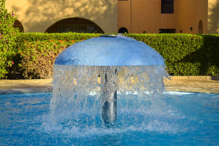 Swimming pool with clear blue water without people. vacation resort. Clear water with blue tint. copyspace. selective focus.の写真素材