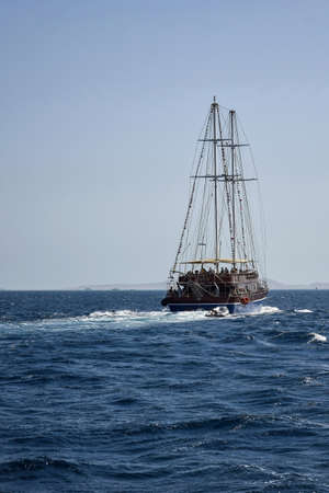 People relax on stylized sailing ship on sunny day. Vacation on Red Sea in Egypt, resort, holidays,...