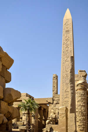 Ruins of Karnak Temple complex with statues, sculptures, pillars and columns carved with ancient Egyptian hieroglyphs and symbols (ancient Thebes). Luxor, Egypt. copyspace. vertical photo.の写真素材