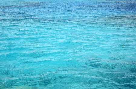 Abstract natural background, surface, texture. Waves of blue sea water. copyspace. selective focus.の写真素材