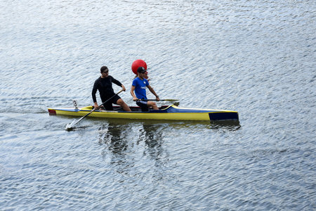 Two young man athletes are sailing canoe on river, controlling oars. Active outdoor sports training. side view. copyspace. Chisinau, Moldova - July 2021のeditorial素材