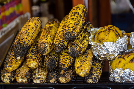 Freshly baked corn on fire. Sale of freshly baked corn at fair. close-up. selective focus.の写真素材