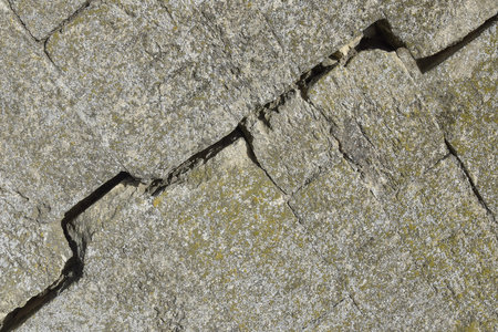 Big crack on gray wall with moss, abstract image of diagonal cleft, background texture. close-up. copyspace. selective focus.の写真素材