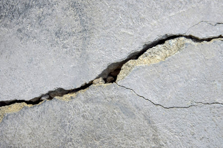 Big winding deep crack on old wall, abstract image of cleft with remnants of old plaster, abstract...