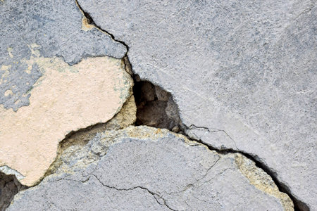 Big deep branched crack on wall with old plaster, abstract image of diagonal cleft. close-up. horizontal photo. copyspace. selective focus.の写真素材