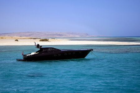 Vacation, active recreation on black yacht on sunny day. Holidays on Red Sea, resort, leisure and adventure, travel. Hurghada, Egypt - October 2021のeditorial素材