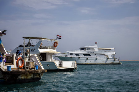 Moored white yachts are waiting for tourists for boat trip. Vacation on Red Sea, resort, holidays,...