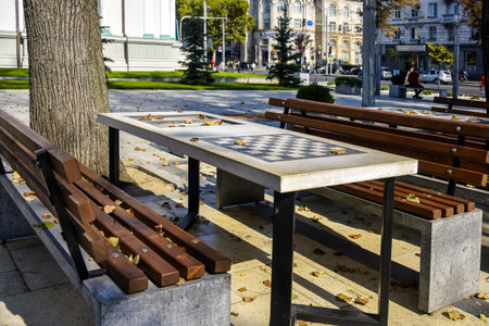 Chess Tables Await Players in a City Park. Autumn cityscape.の写真素材