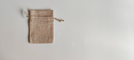Drawstring bag mockup, crafted from soft linen on on gray background. Still life, simple...