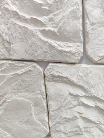 Wall decoration with artificial wild gray stone of arbitrary shape. Finishing works, wall cladding....