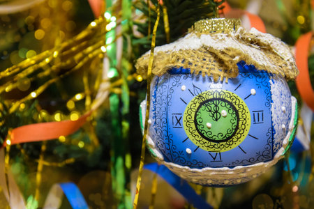 Vintage Christmas toy ball on artificial christmas tree. Ornaments for the New Year, old-fashioned decoration. Close-up. Selective focus.の写真素材