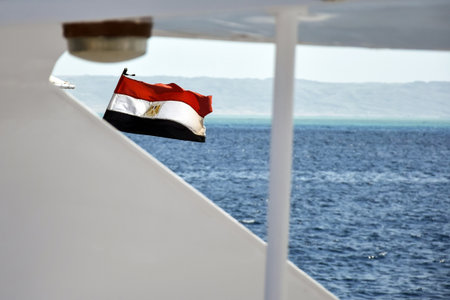 Egyptian flag is fluttering in wind on yacht. Close-up. Picturesque seascape with mountain views. Copy space.の写真素材