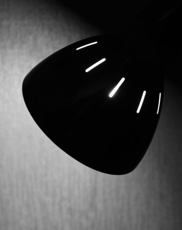 Soft light from lamp on wall. Lighting of dark room in evening time. Copy space. Soft focus.の写真素材