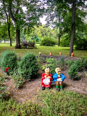 Pleasant decorative installation in rustic style with dolls of grandparents. Beautiful decoration of city parks.の写真素材