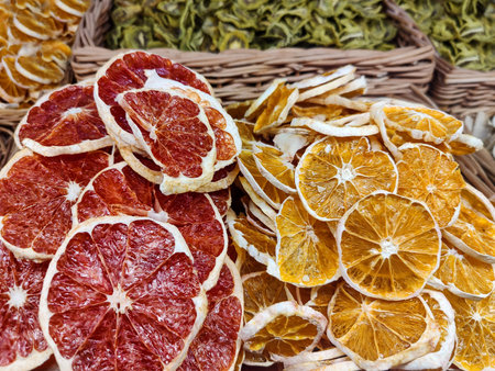 Dried sliced fruits oranges, grapefruit and kiwis on store counter. Close-up.の写真素材