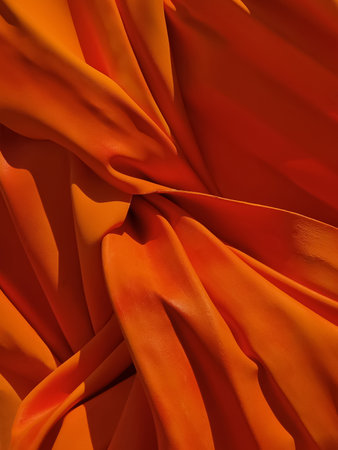 Abstract imitation of orange georgette or satin fabric made of paper. Spectacular background and texture. Close-up.の写真素材