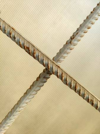 Intersection of bars of reinforcement on background of cloudy glass. Copy space. Close-upの写真素材