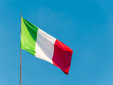 the Italian flag waving in a blue skyの写真素材