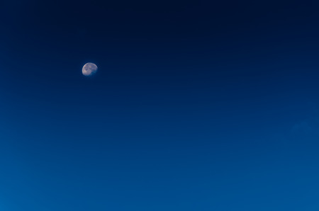 blusky with white moon, nature backgroundの写真素材