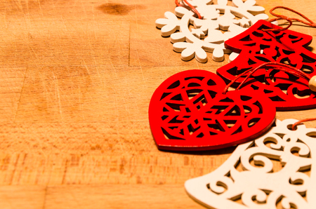 still life with wooden shapes of some christmas symbol: heart, christmas tree, snowflake, bell.の写真素材
