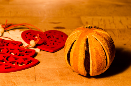 still life with a christmas orange and wooden ornament.の写真素材