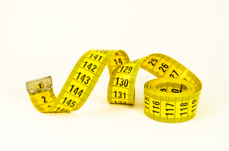 still life with a yellow tape measure, symbol of business, sizing, goal and dietの写真素材
